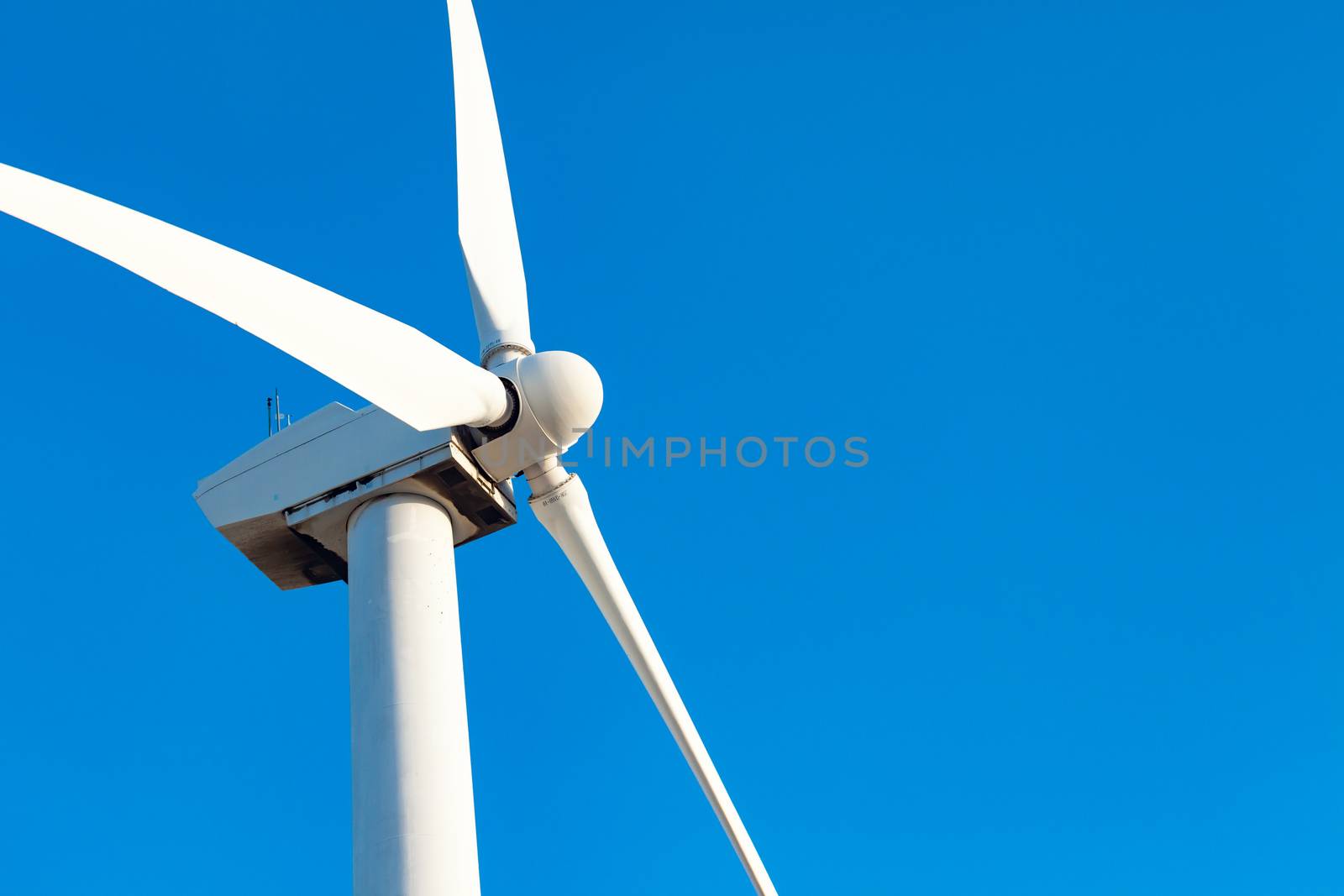 Single Wind Turbine Over Dramatic Blue Sky by Feverpitched