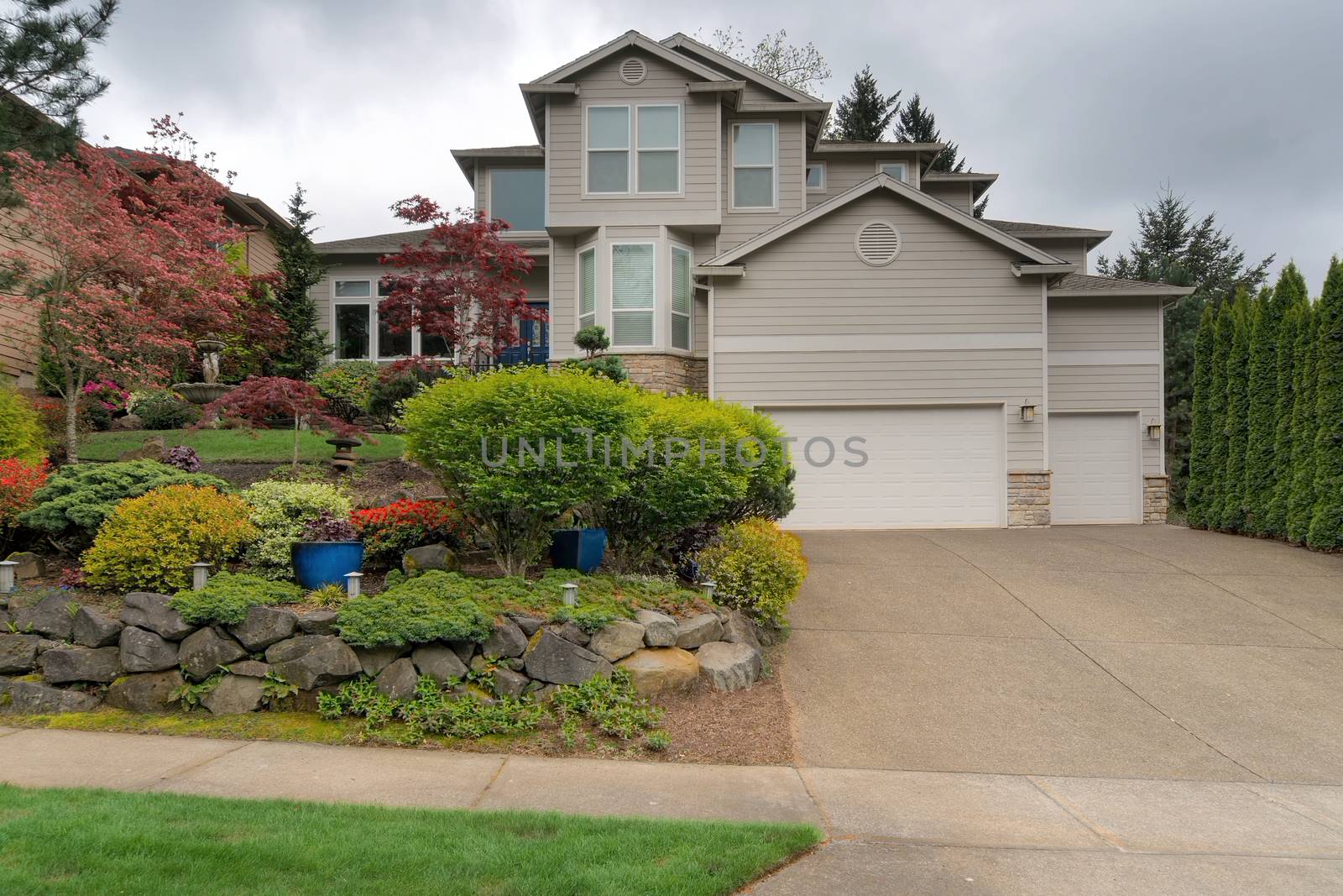 Single family home in North American suburban neighborhood with front yard garden landscaping in spring season