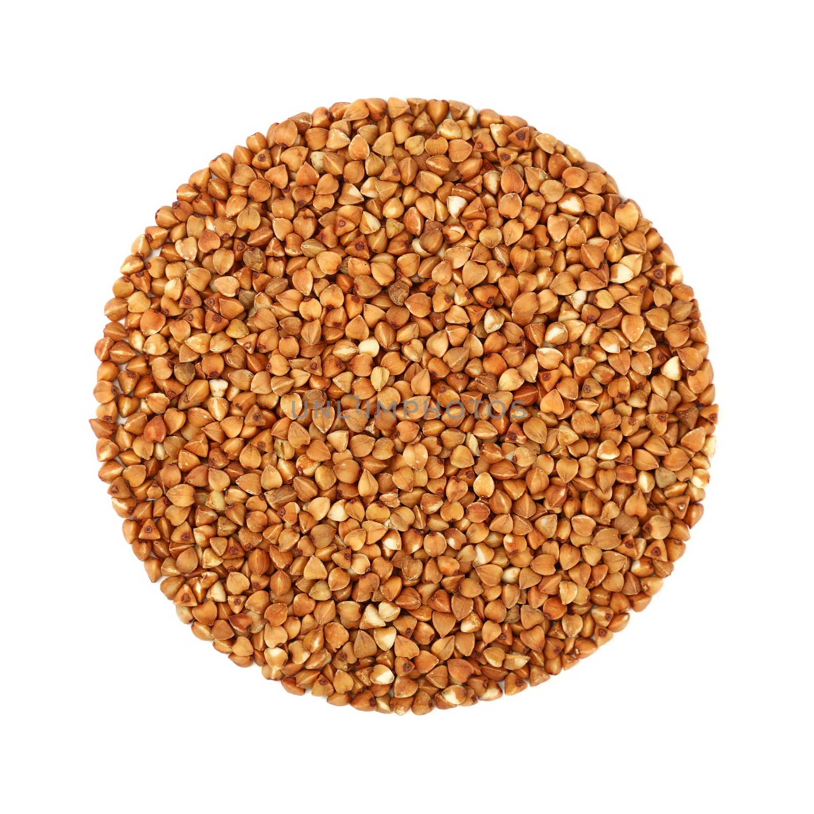 Round shaped dried brown buckwheat (Fagopyrum esculentum) groats isolated on white background, close up, elevated top view