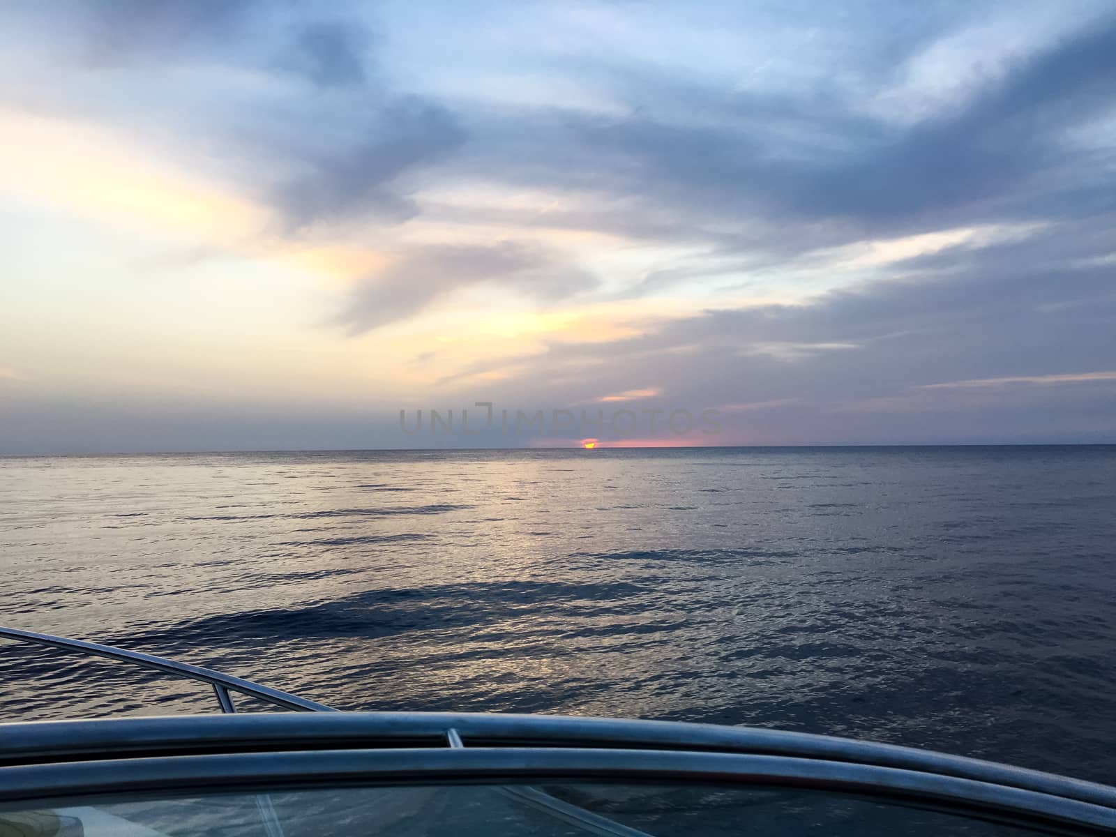view from the boat to the sunset at the ocean by Tevion25