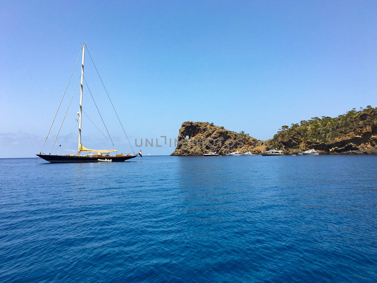 a sailship on the ocean is ready to start from the bay