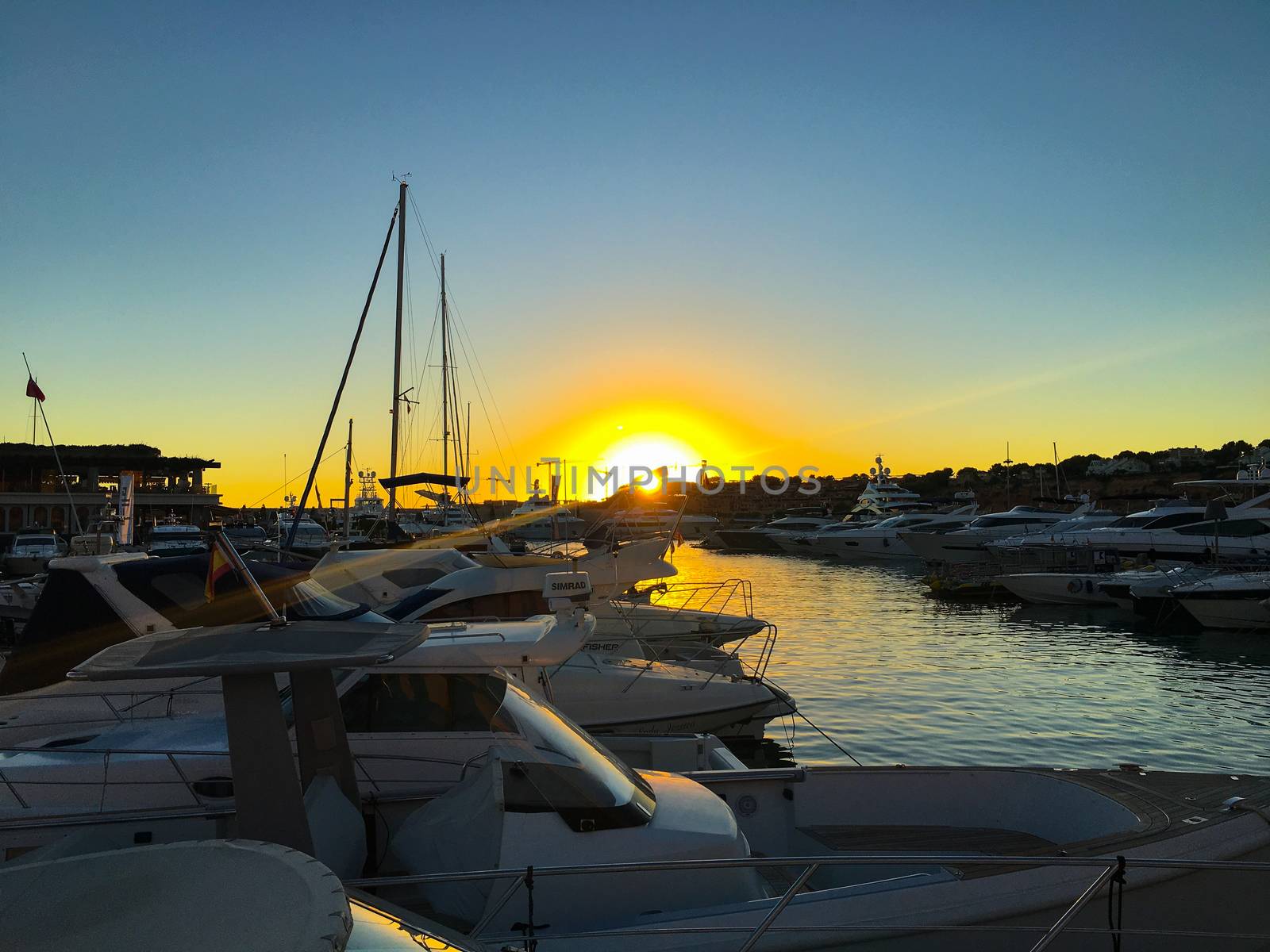 wonderful sunset at the pier with sailboats by Tevion25