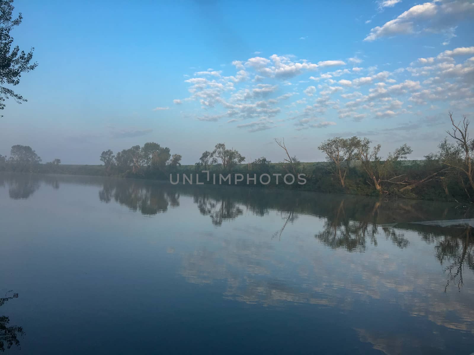 a venice canal with fog and reflection at summer