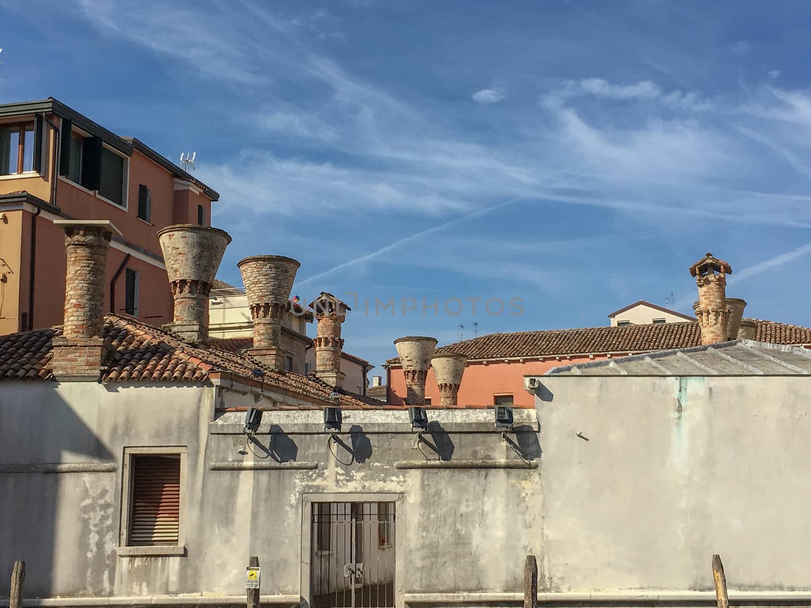 venice roofs with an old house in front at summer