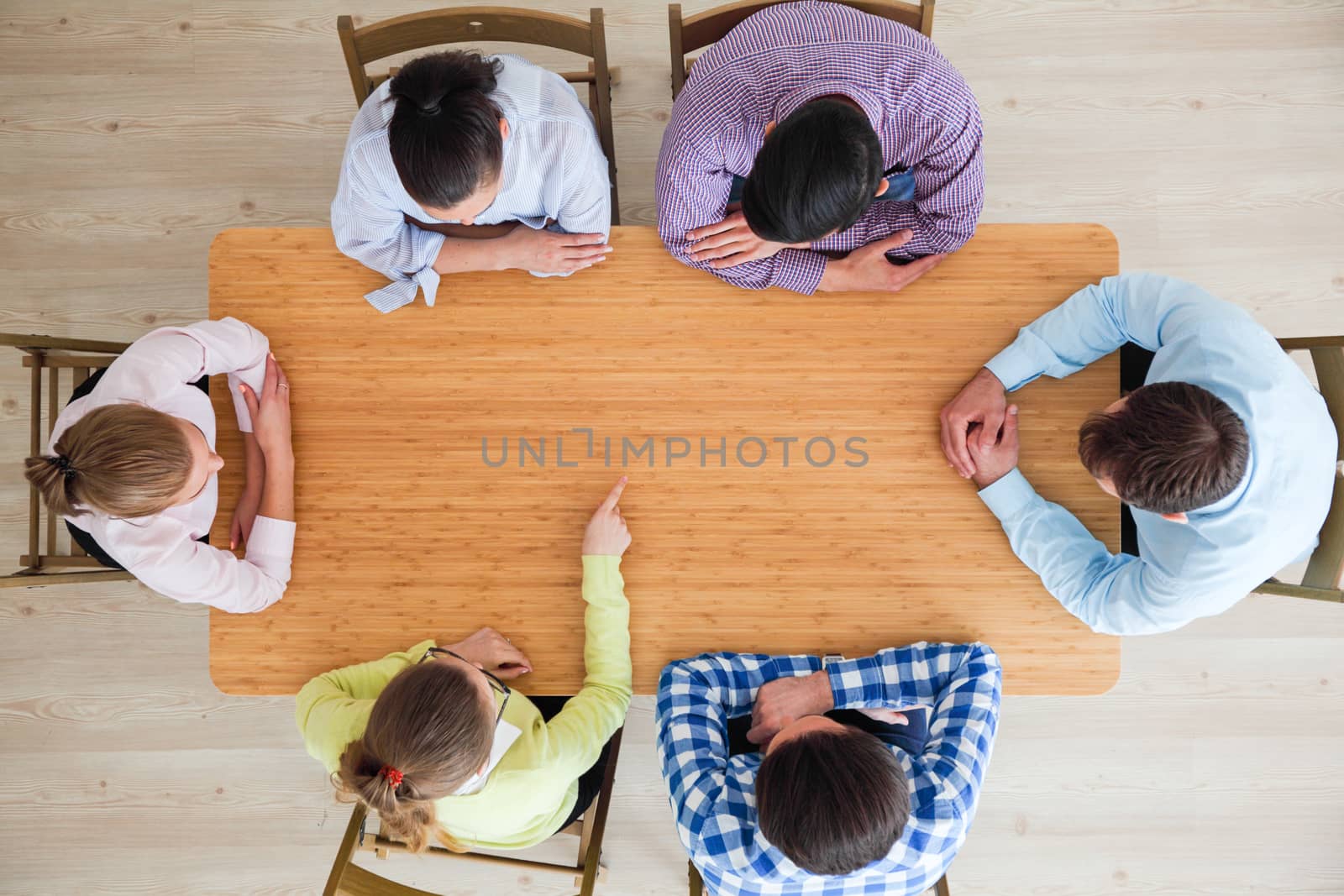 Hipster business teamwork brainstorming planning meeting concept, people team sitting around the table pointing to copy space