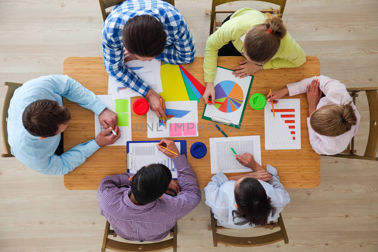 Business team meeting, people in casual clothes working with financial statistics at office desk