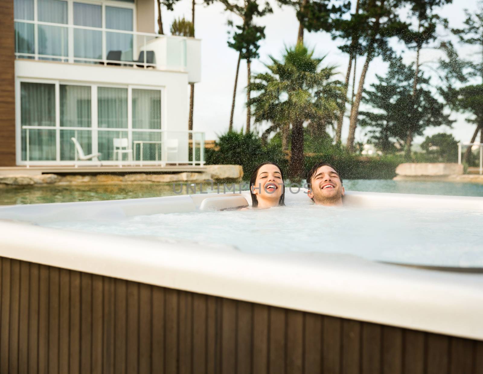 Young couple in a jacuzzi by Iko