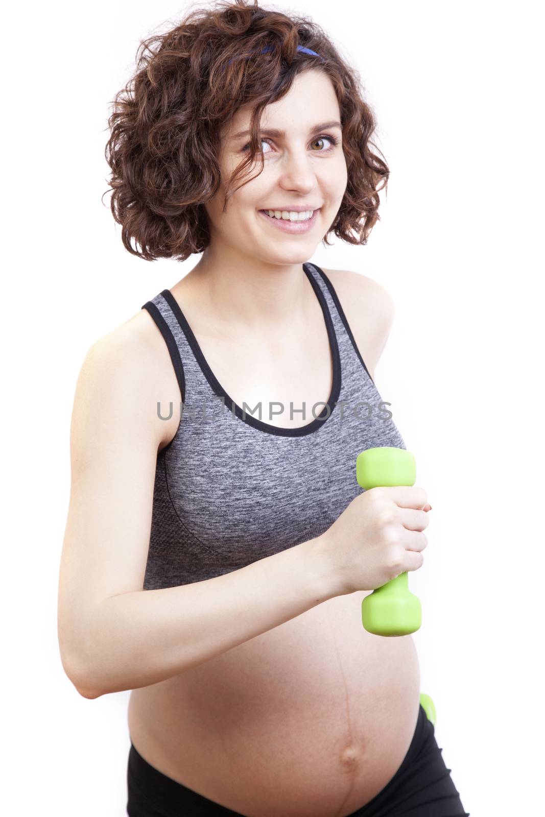 Young pregnant woman practicing fitness. Isolated on white background