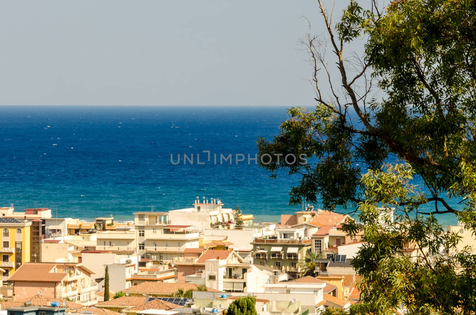 In the blue intensity of the Mediterranean Sea, overlook the houses of a Sicilian country