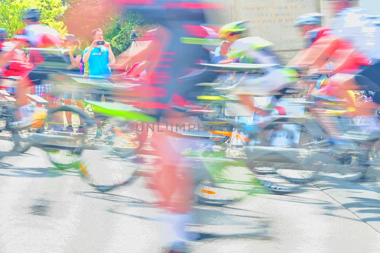 Abstract arty background : motion blur of bicycle racers competing on city streets. Tour of cycling. Blurry background sport with cyclists.