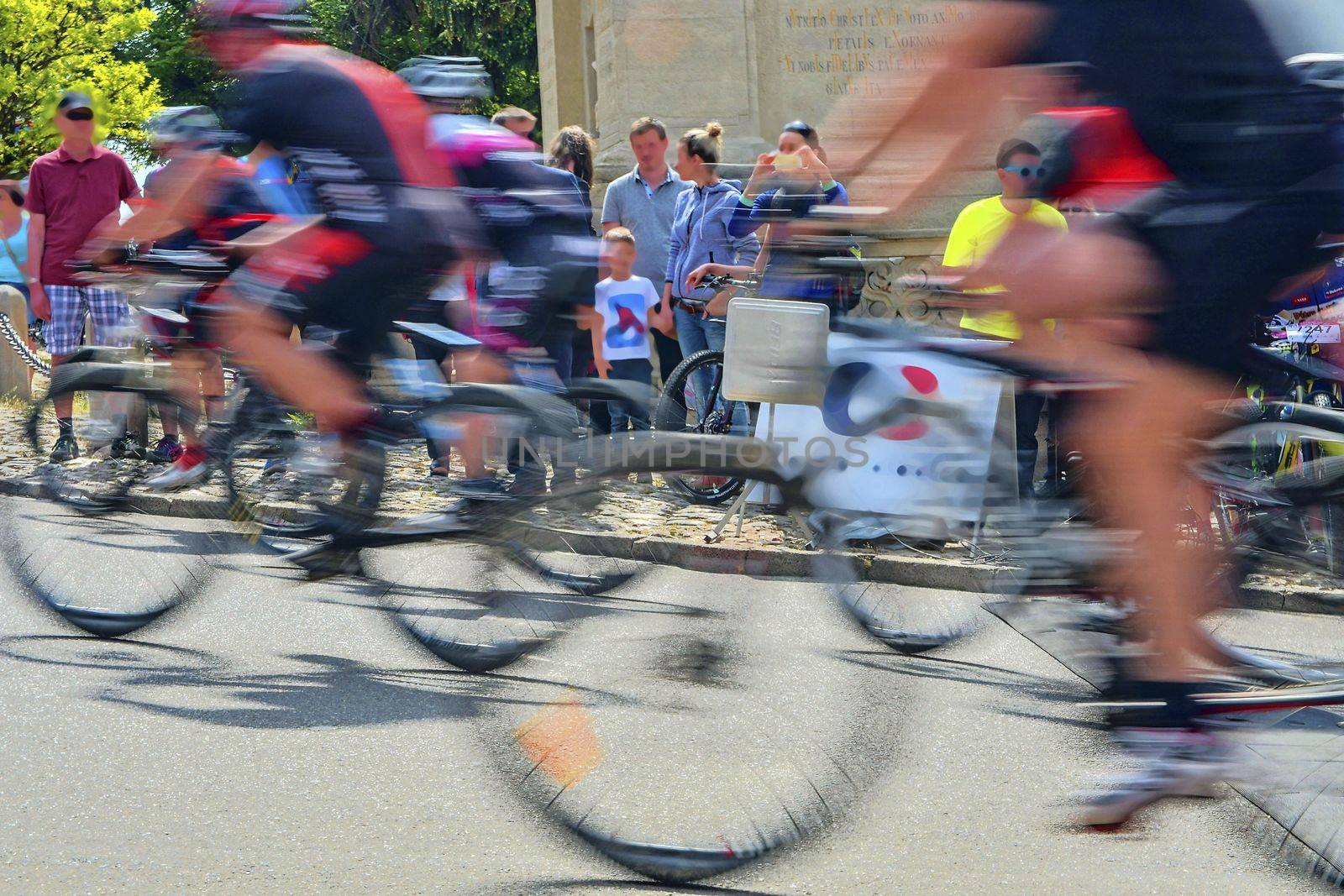 Abstract arty background : motion blur of bicycle racers competing on city streets. Tour of cycling. Blurry background sport with cyclists.