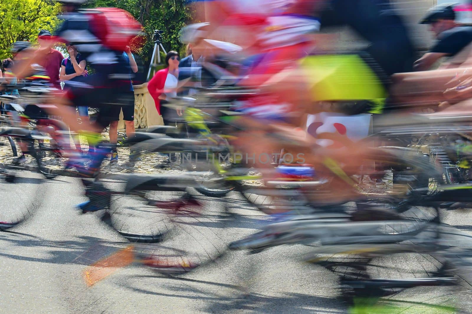 Abstract arty background : motion blur of bicycle racers competing on city streets. Tour of cycling. Blurry background sport with cyclists by roman_nerud