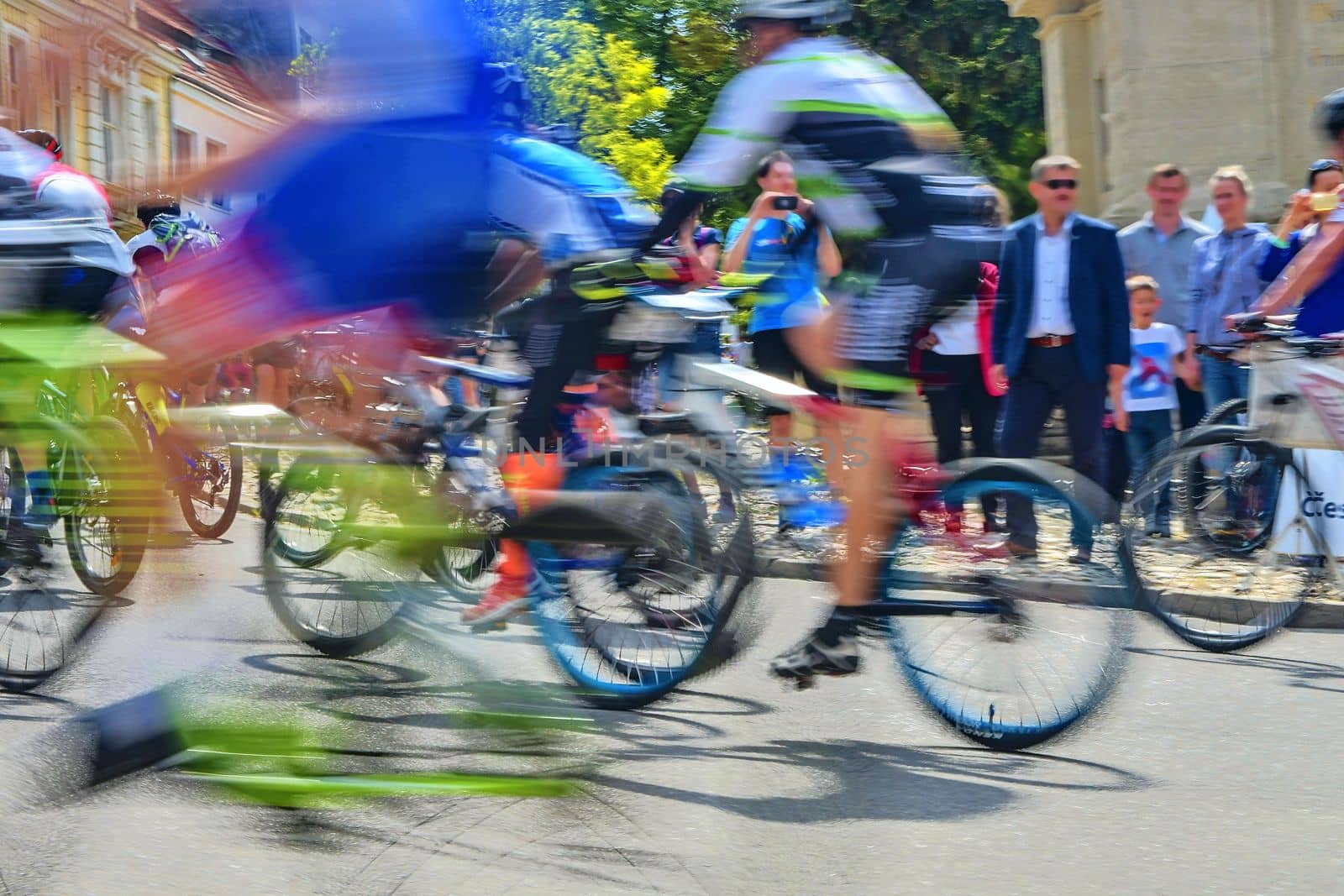 Abstract arty background : motion blur of bicycle racers competing on city streets. Tour of cycling. Blurry background sport with cyclists.