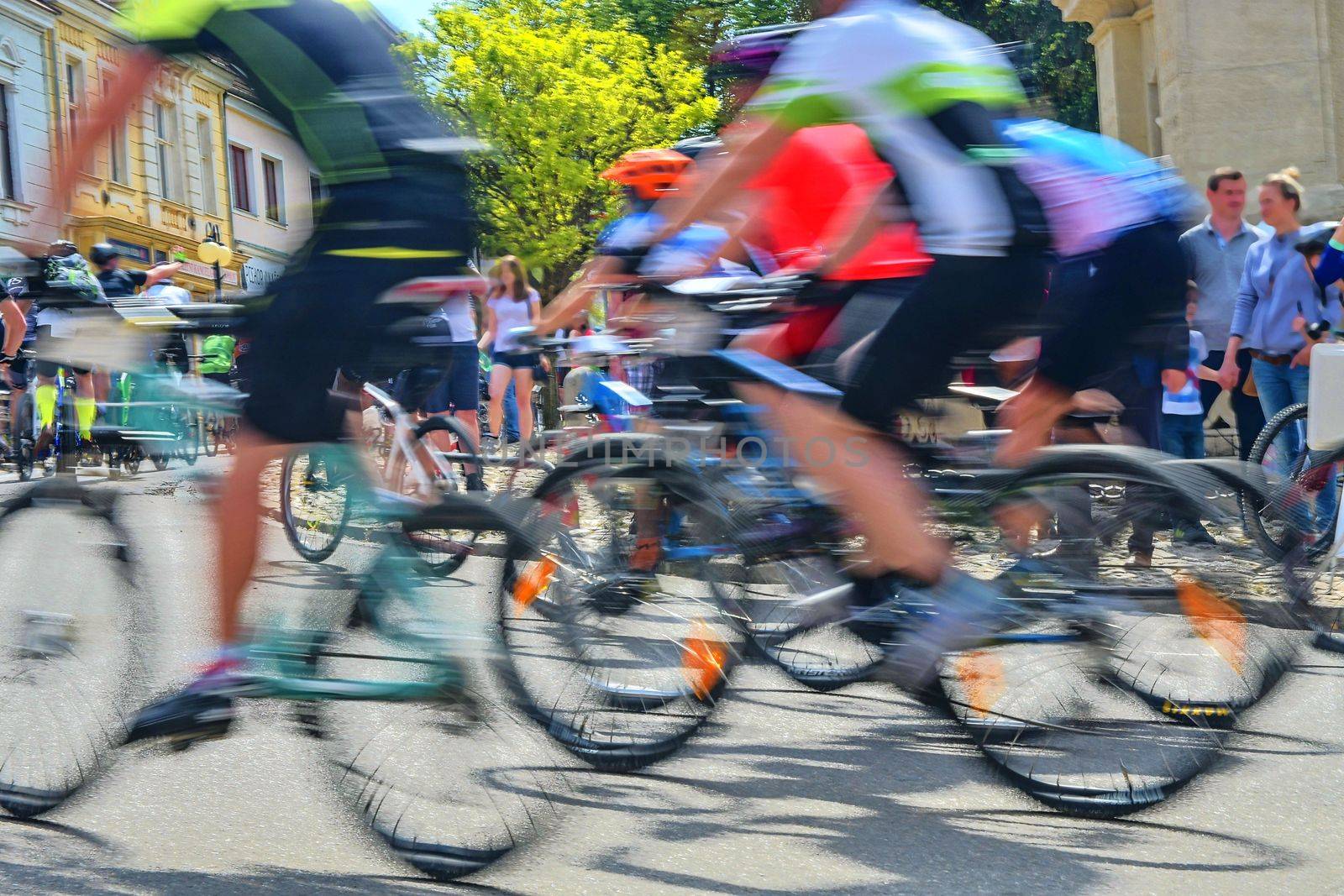 Abstract arty background : motion blur of bicycle racers competing on city streets. Tour of cycling. Blurry background sport with cyclists by roman_nerud