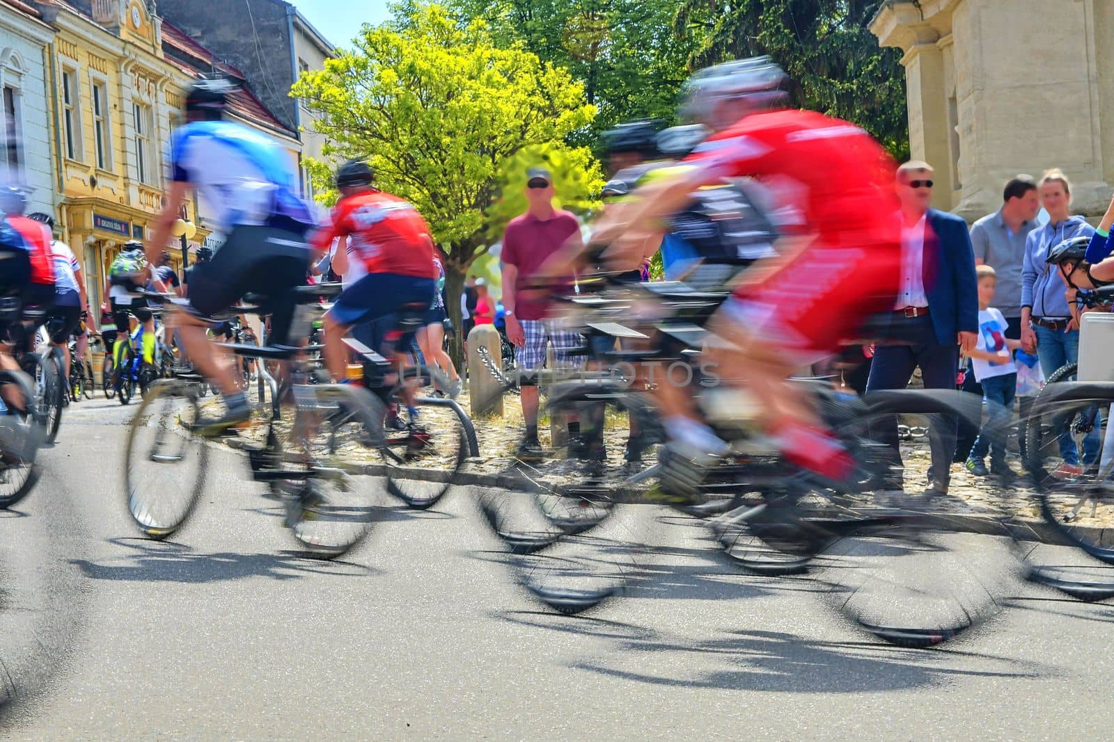 Abstract arty background : motion blur of bicycle racers competing on city streets. Tour of cycling. Blurry background sport with cyclists by roman_nerud