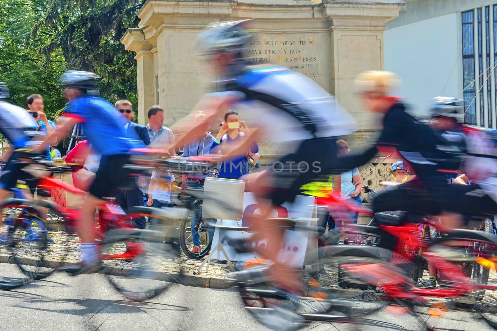 Abstract arty background : motion blur of bicycle racers competing on city streets. Tour of cycling. Blurry background sport with cyclists.