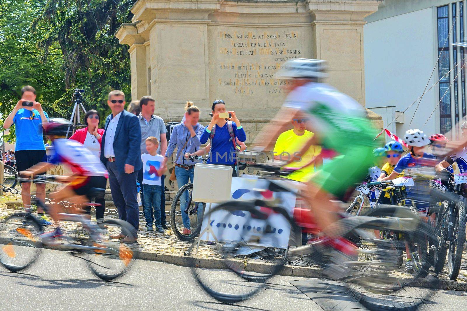 Abstract arty background : motion blur of bicycle racers competing on city streets. Tour of cycling. Blurry background sport with cyclists by roman_nerud