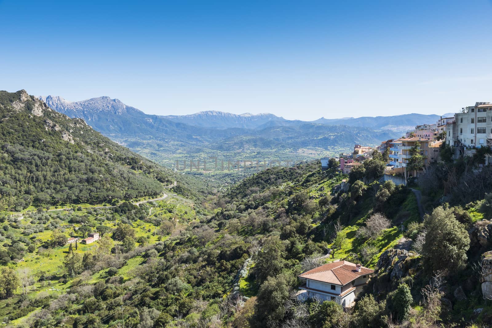 the mountains in the centre of sardinia island, with the village of orgosolo on the right and the small road on the background, this roads are typical for the sardegna island