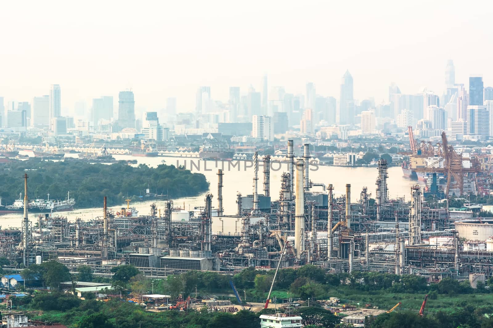 Oil refinery industry And Petrochemical plant with white sky city view