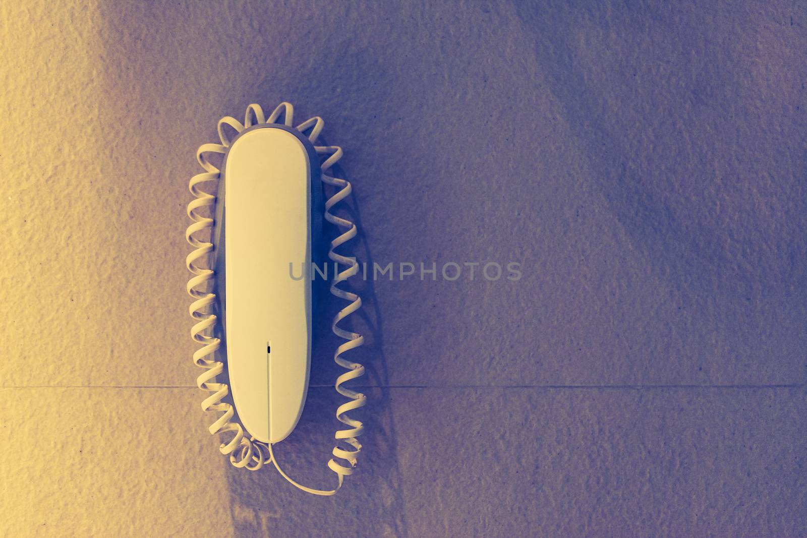 intercom home hung on a white wall,White plastic phone on a wall by ahimaone