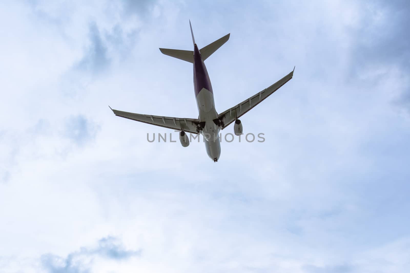 Under view of Airplane in the cloudy sky for background