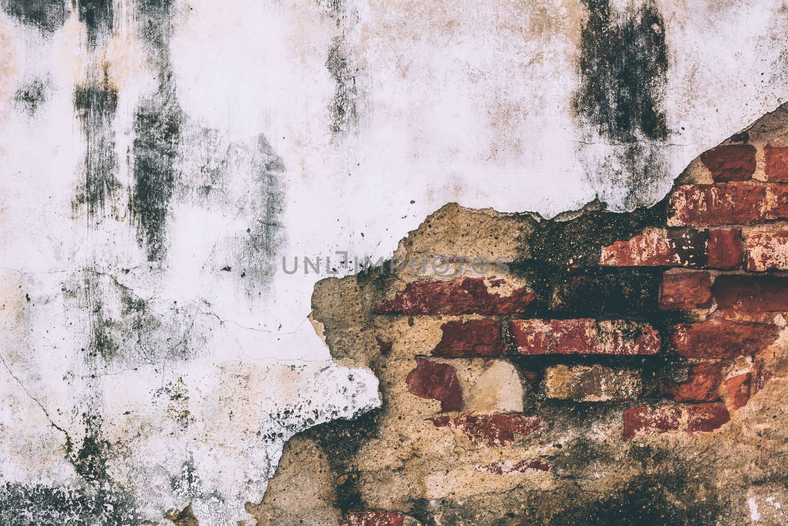 Aged brick wall with cracked plaster background tone vintage