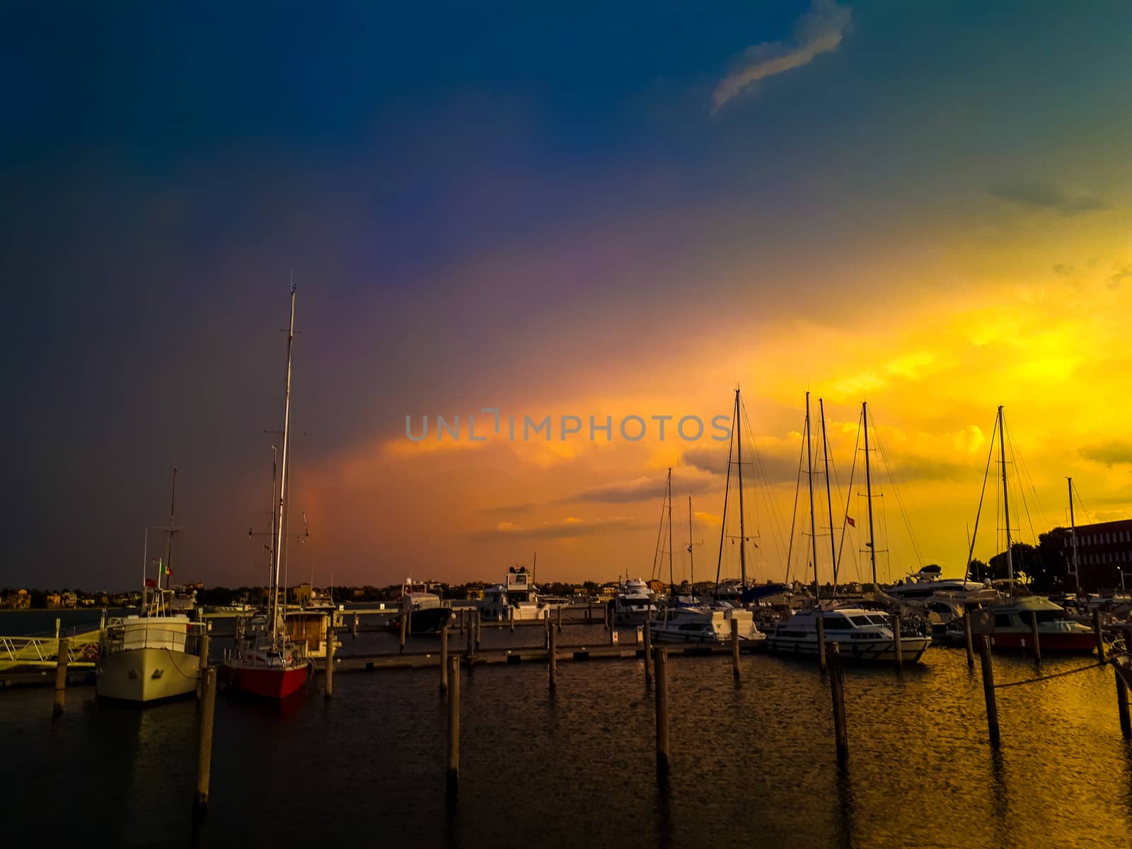 sunset in venice with boats at the pier