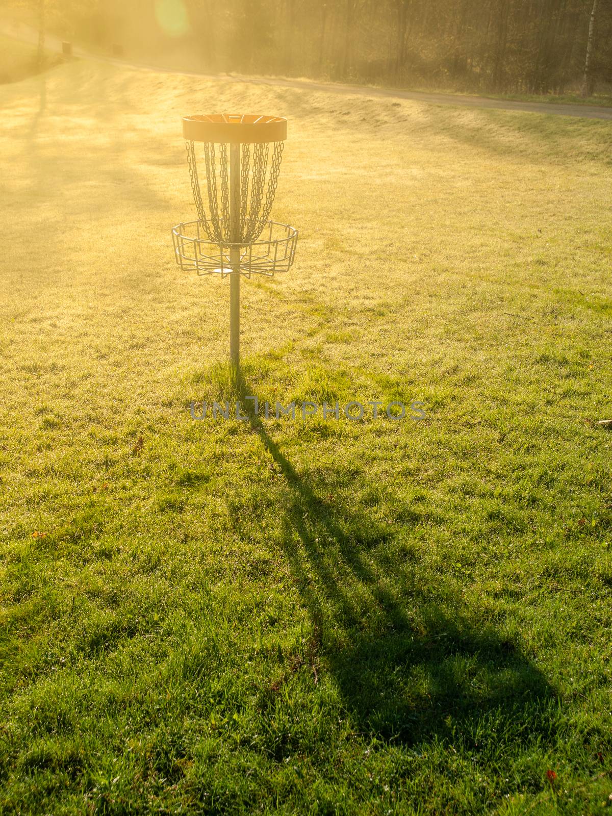 Disc golf hole basket in autumn park