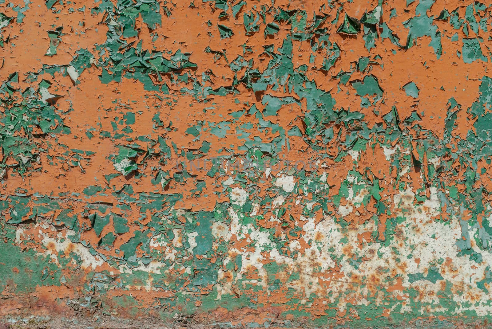 fragment of a rusty iron surface covered with old paint, which has long been under the influence of different climatic conditions