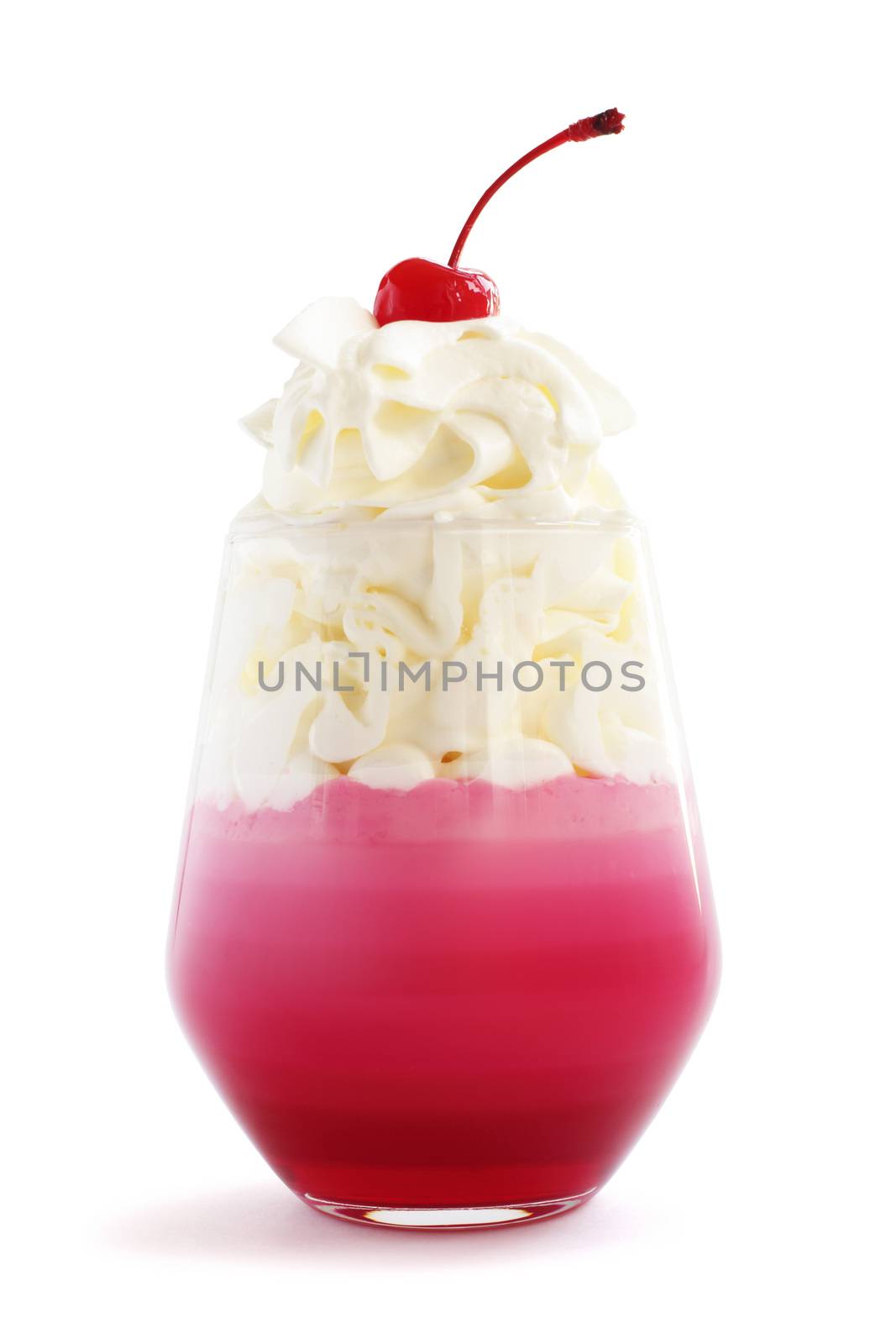 Pink striped jello dessert in glass with whipped cream and red candied cherry on top isolated on white background