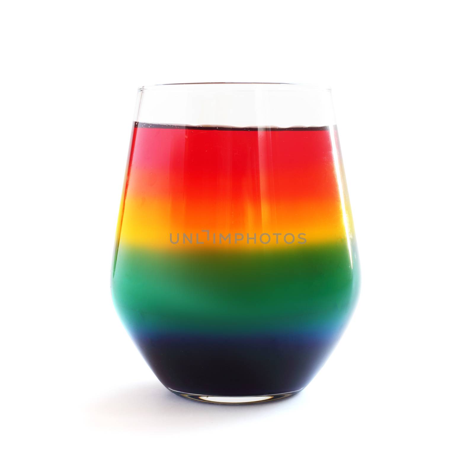 Rainbow Jello dessert in glass isolated by destillat