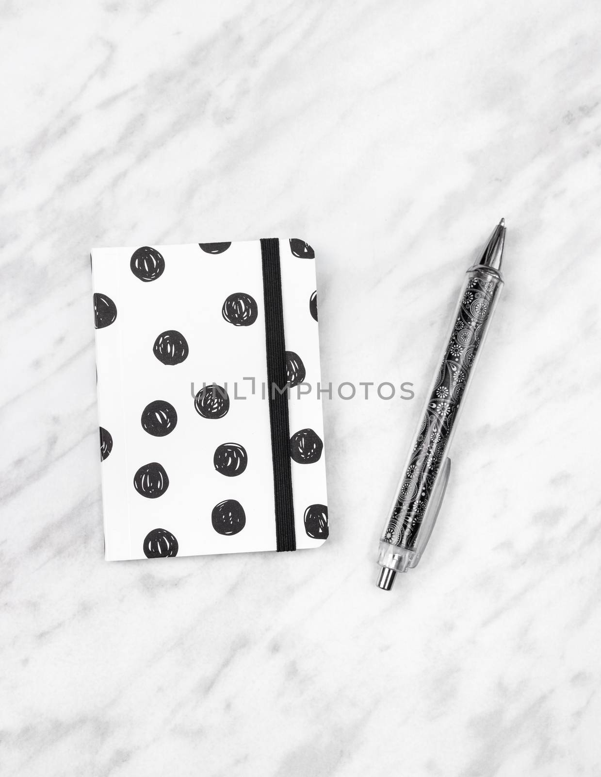 Black and white diary and pen on marble background by anikasalsera