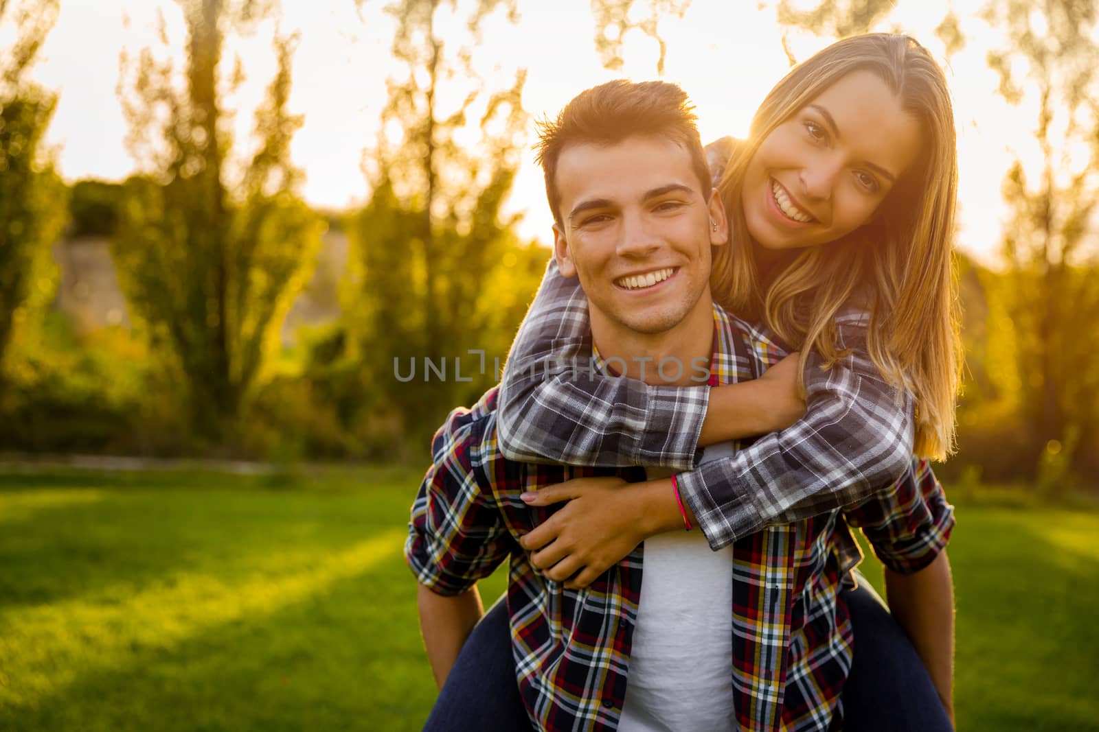 Portrait of a happy young couple in the nature hugged together