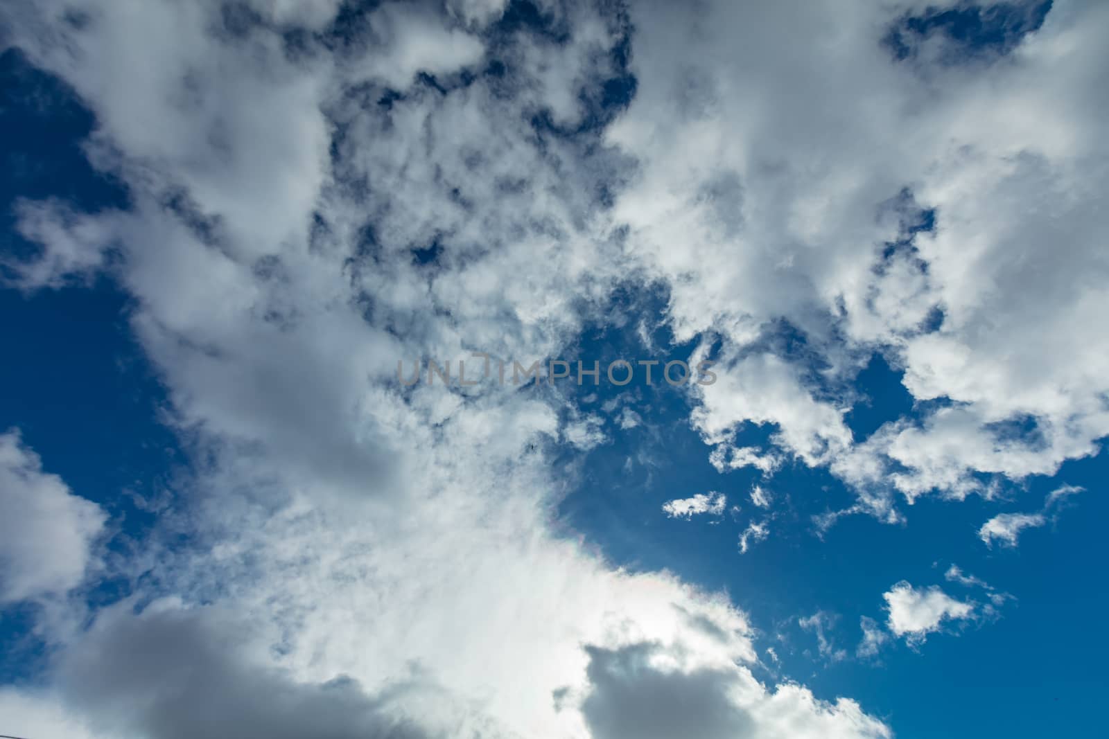 Deep blue bright sky with clouds background