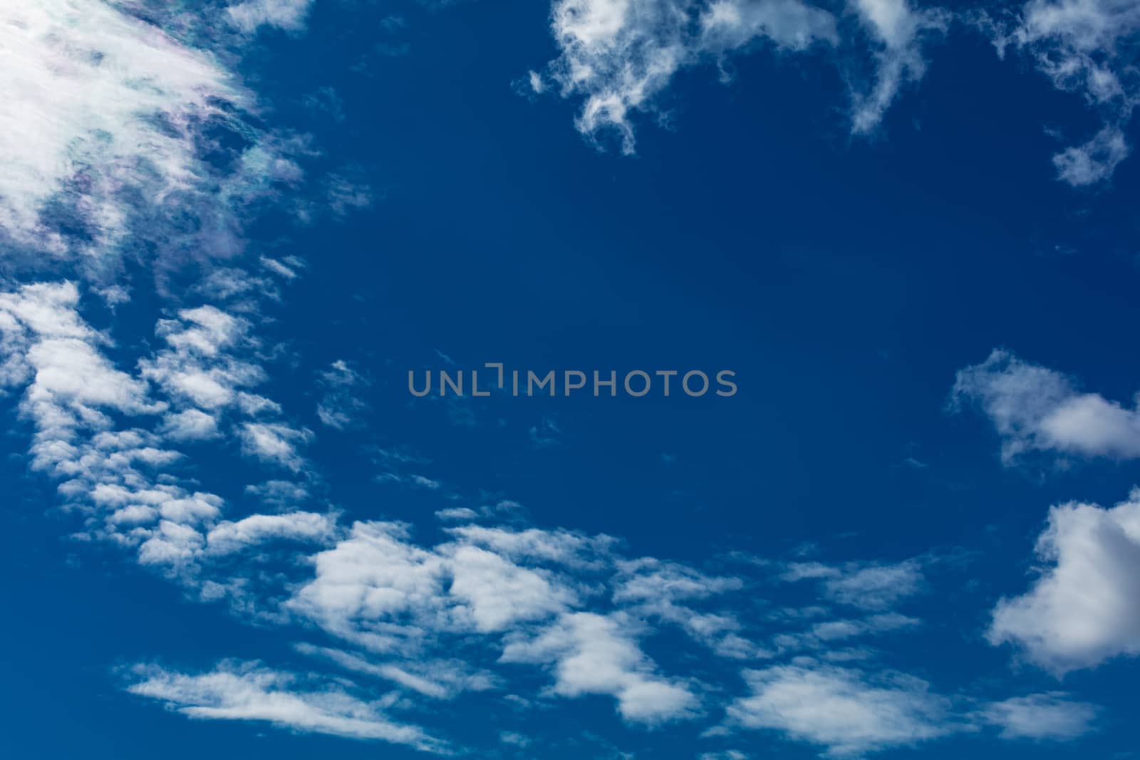 Deep blue bright sky with clouds background