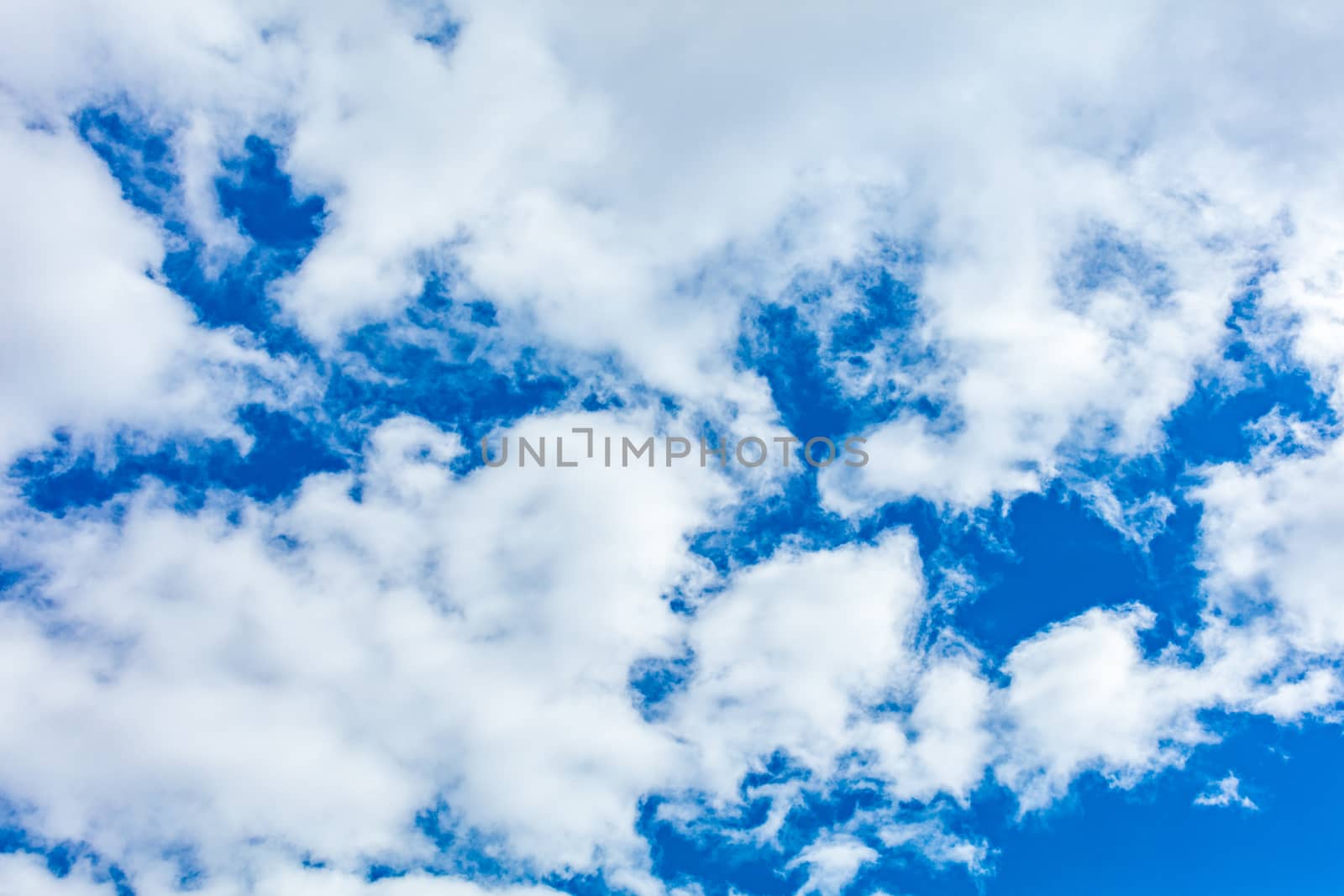 Deep blue bright sky with clouds background