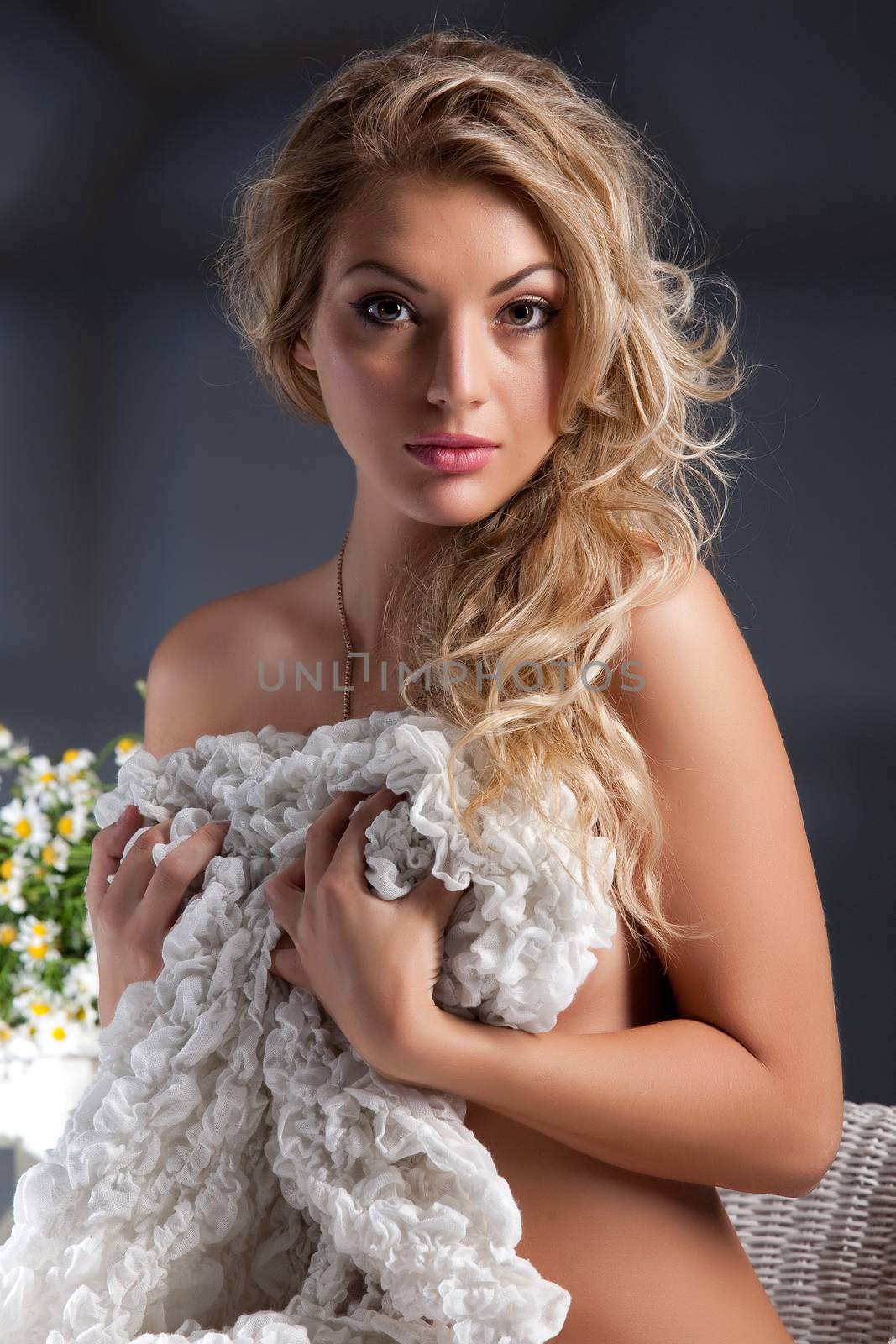 Young beautiful woman sitting in a wicker armchair