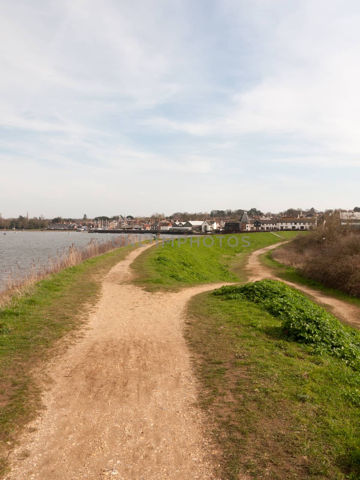 long walkway trail at side of bay of water uk manningtree nature background by callumrc
