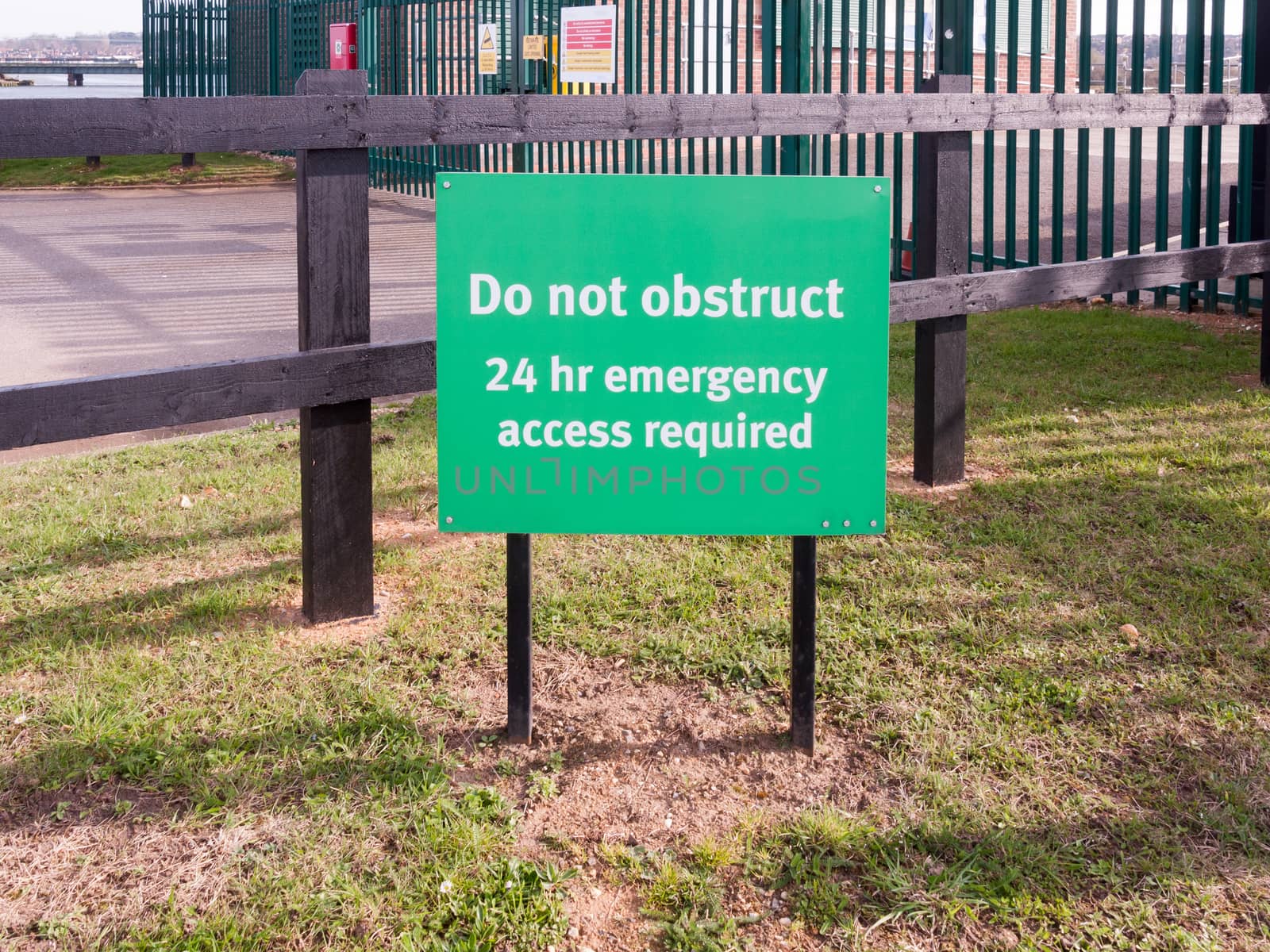 green sign do no obstruct 24 hr emergency access required ; essex; england; uk