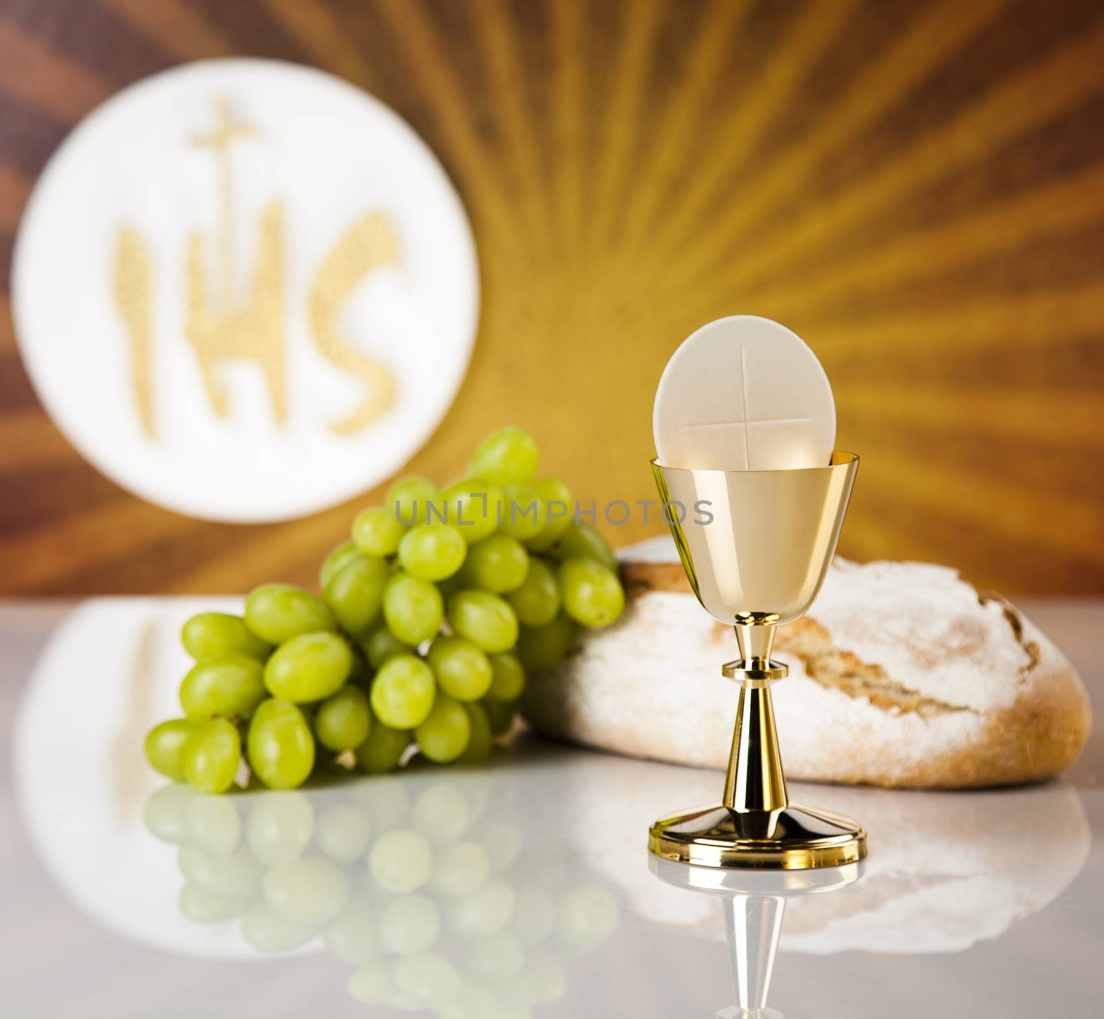 Holy communion a golden chalice with grapes and bread wafers