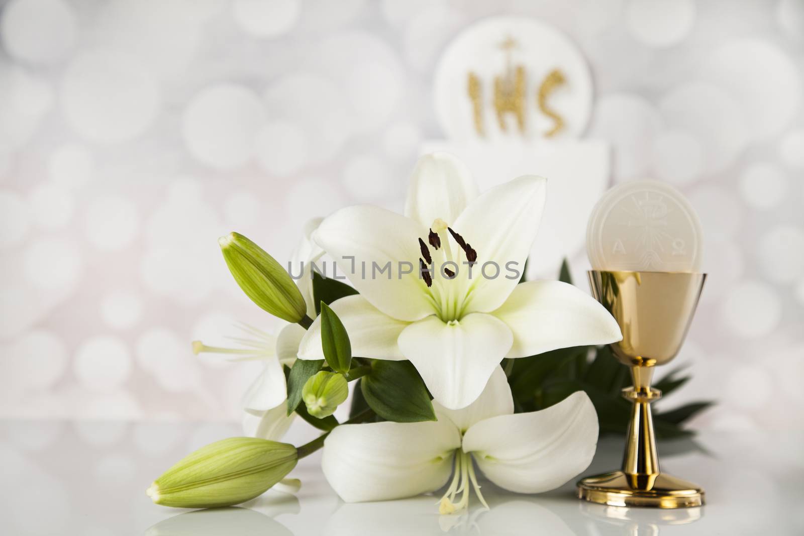 Holy communion a golden chalice with grapes and bread wafers