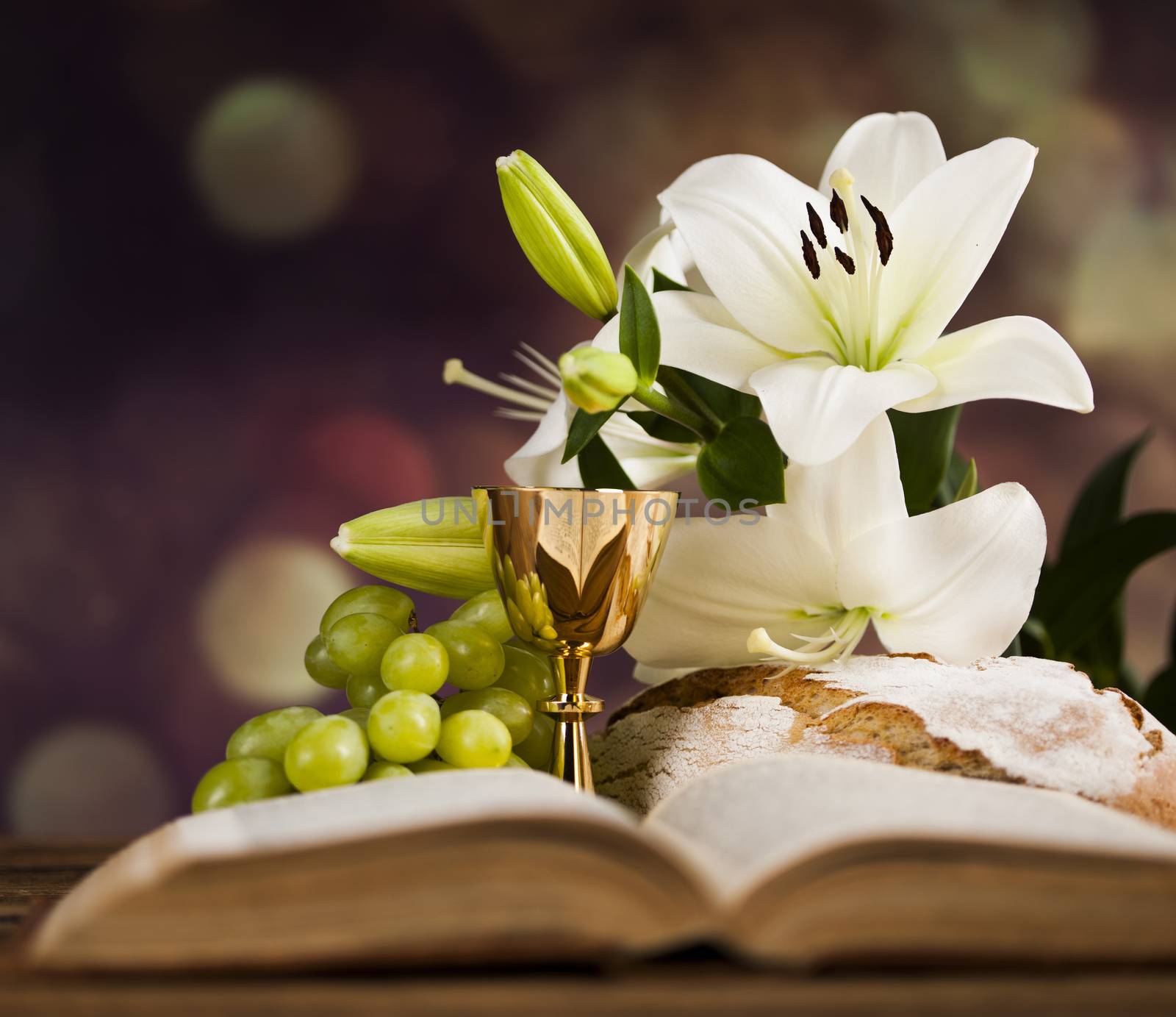 Holy communion a golden chalice with grapes and bread wafers