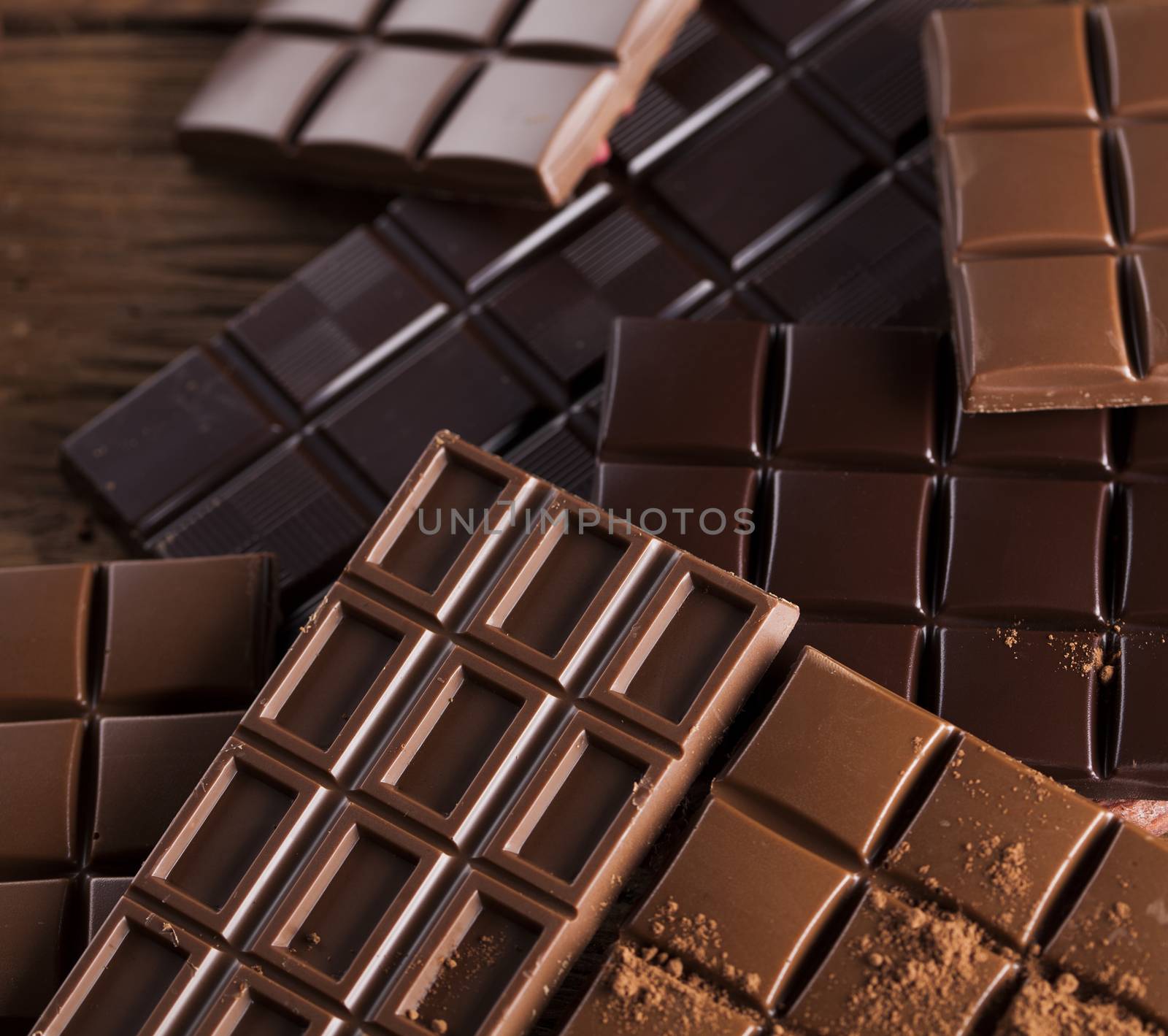 Dark homemade chocolate bars and cocoa pod on wooden  by JanPietruszka