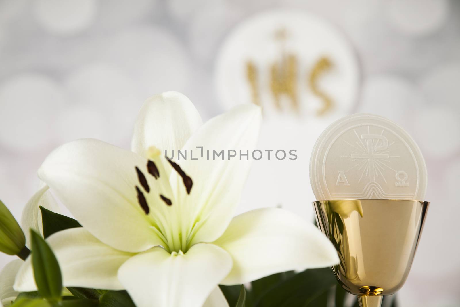 Holy communion a golden chalice with grapes and bread wafers