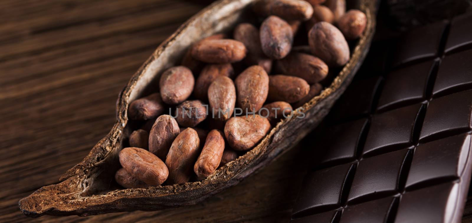 Cocoa pod and cocoa beans on the wooden table by JanPietruszka