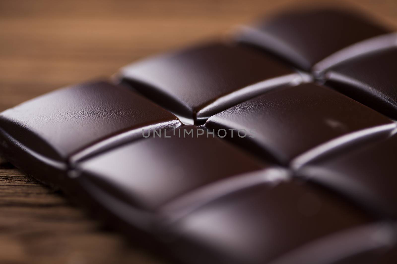 Dark homemade chocolate bars and cocoa pod on wooden  by JanPietruszka