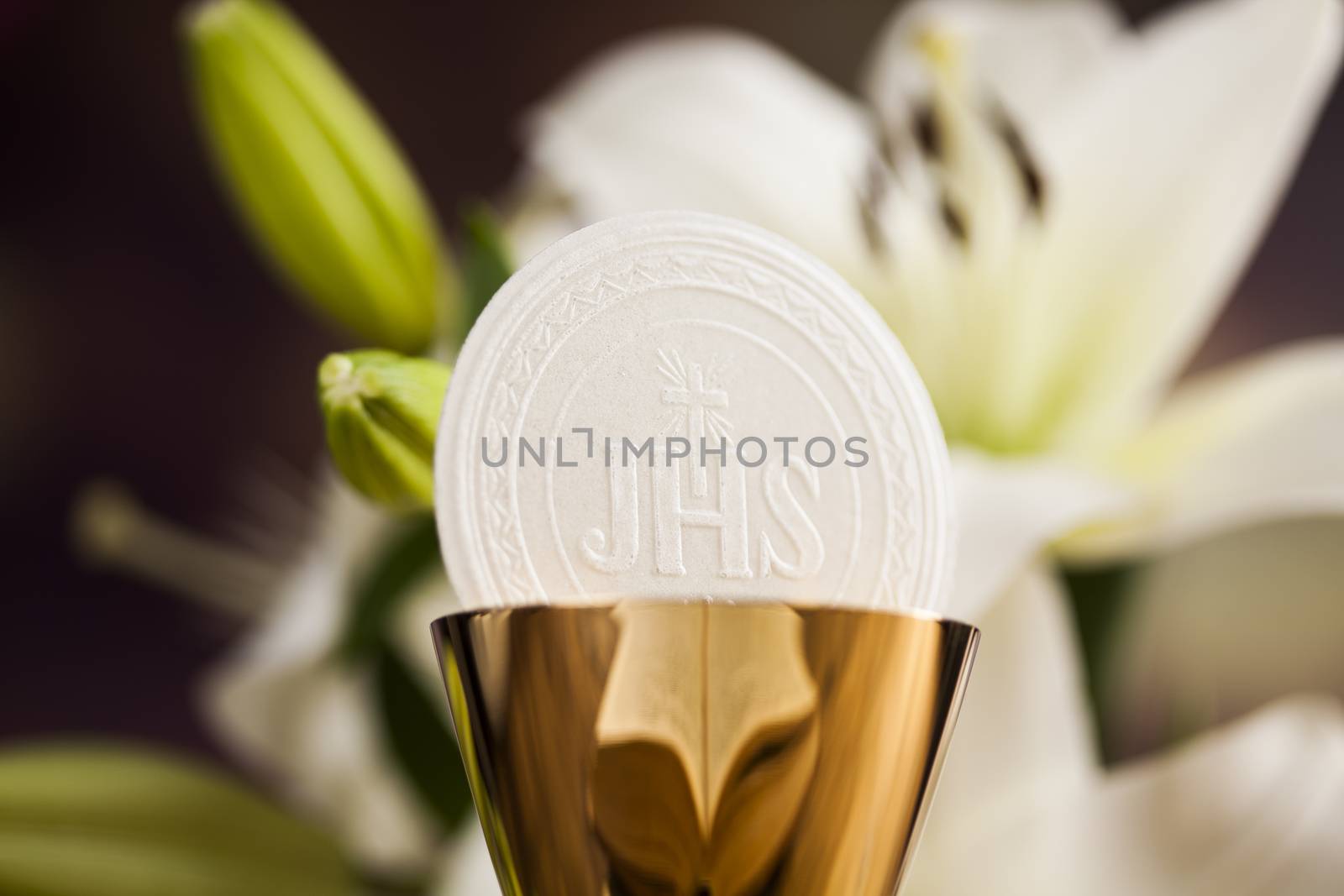 Holy communion a golden chalice with grapes and bread wafers