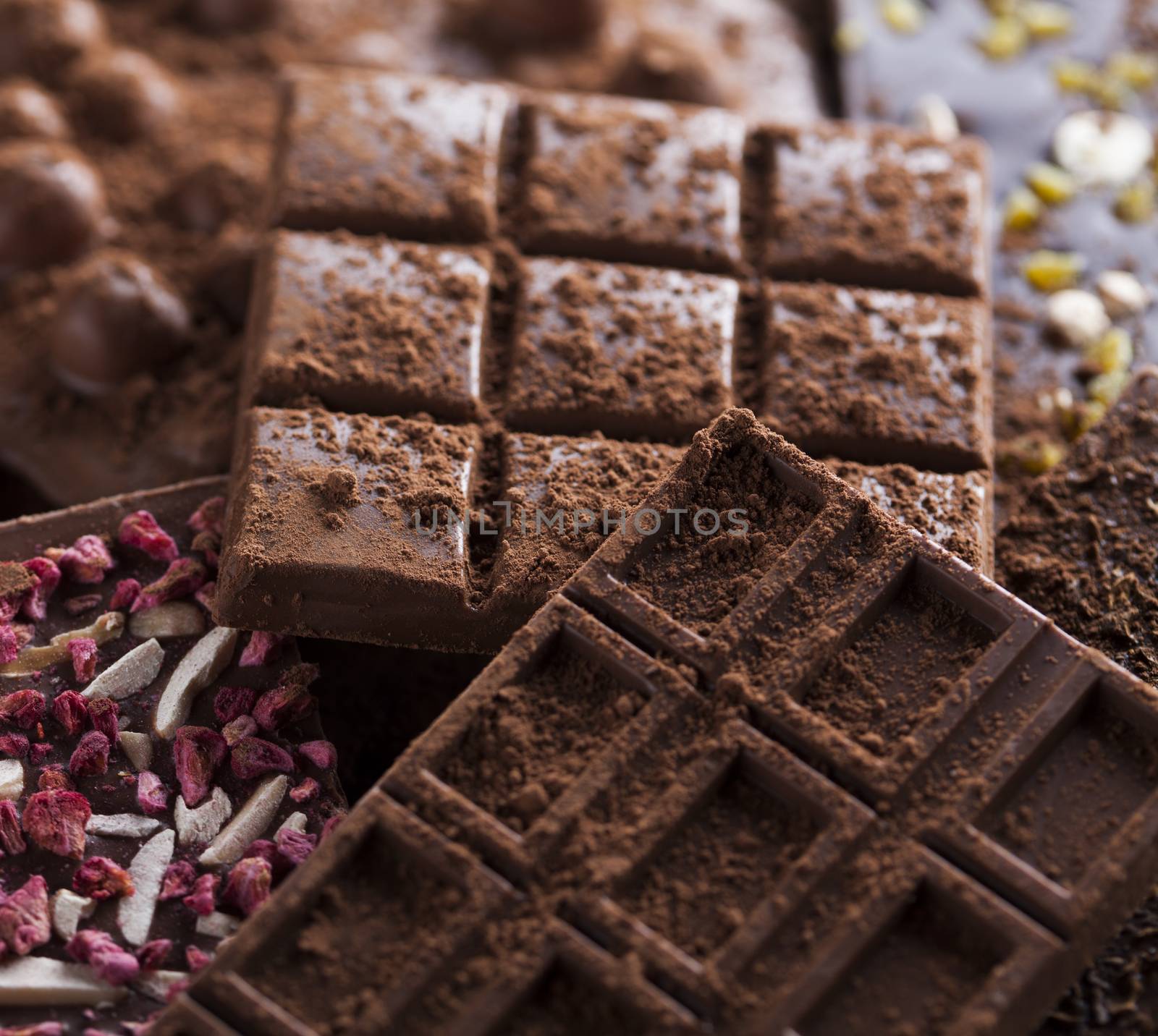 Dark and milk chocolate bar on a wooden table  by JanPietruszka