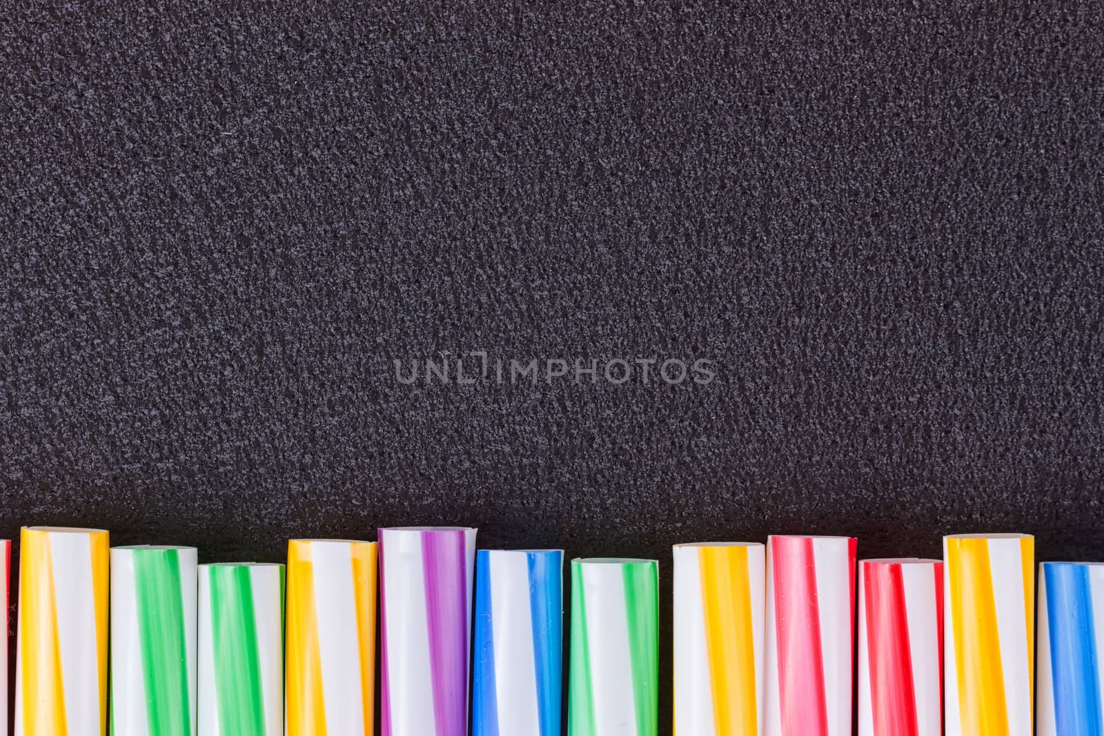 cocktail colorful plastic tube on a black background