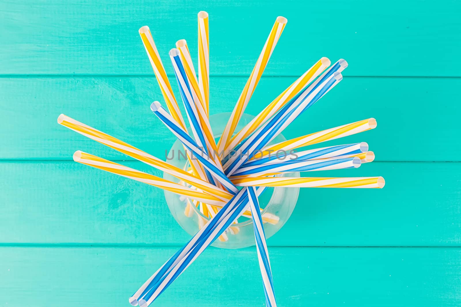 Colorful cocktail tubes in a glass cup